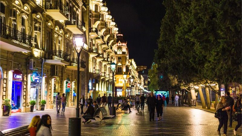 A street lit up with lights in Baku