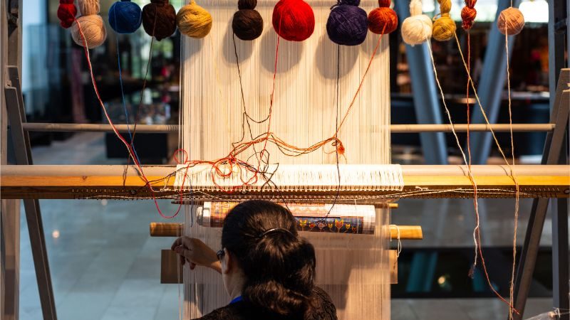 A woman weaving carpets in Baku