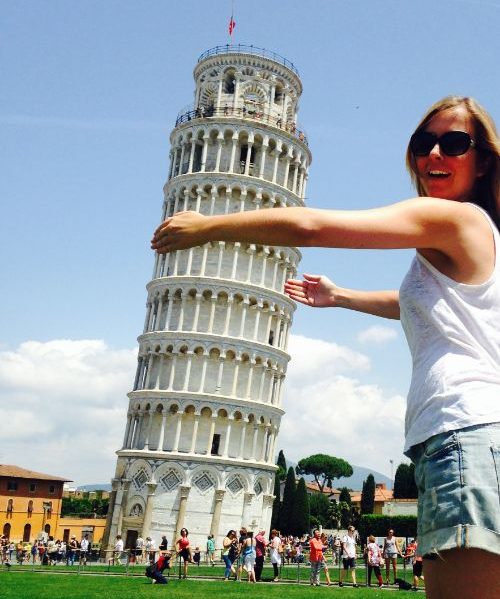 Woman "hugging" the leaning tower of Pisa.