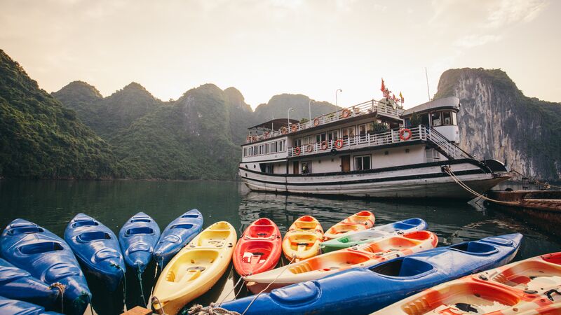 Kayaks and a houseboat in Halong Bay, Vietnam