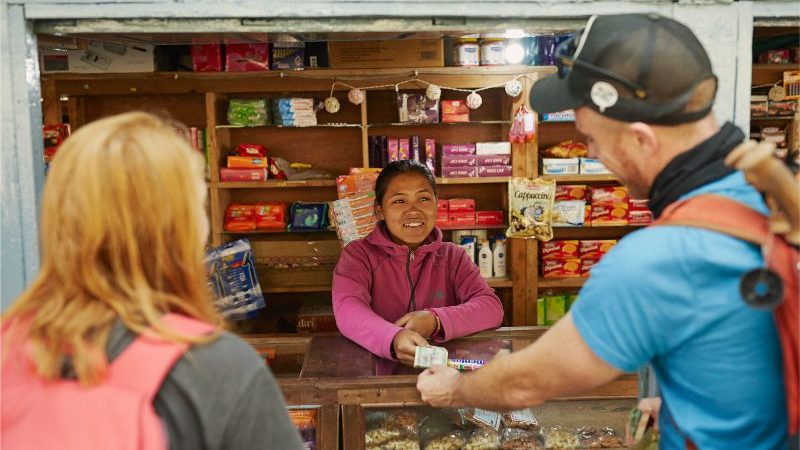 Two hikers buying a snack on the Annapurna Base Camp trail