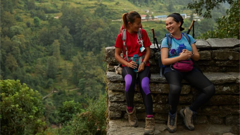 Two hikers stop for a rest on the Annapurna Base Camp trail