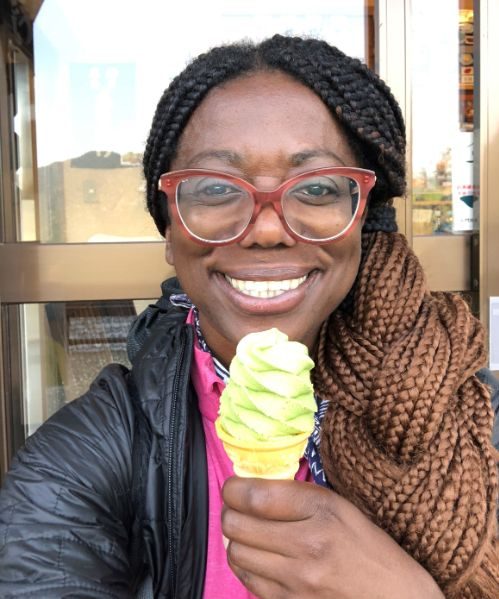 Smiling woman eating an ice cream