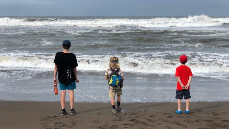 Three boys on a beach in Costa Rica