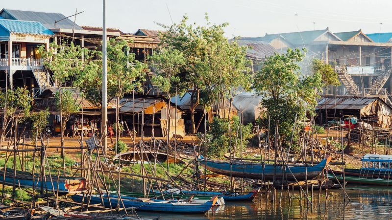 Canoes and riverside houses in Kampong Chhnang, Cambodia