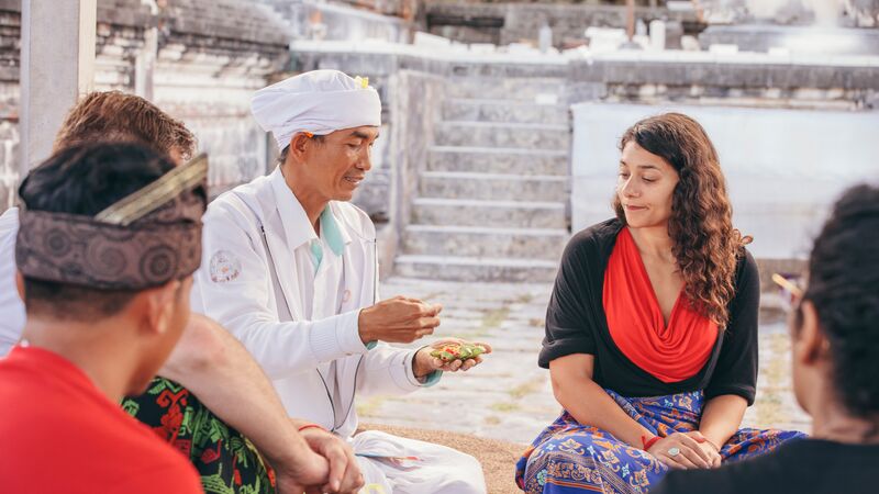 A group of travellers at a temple in Bali.