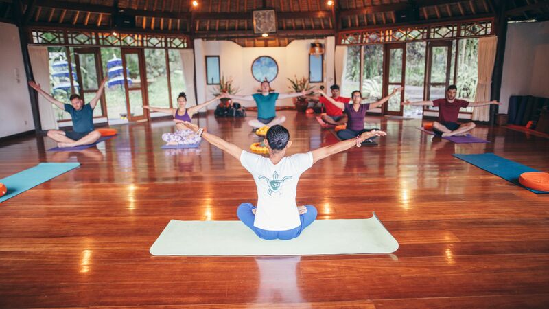 Group of travellers doing yoga