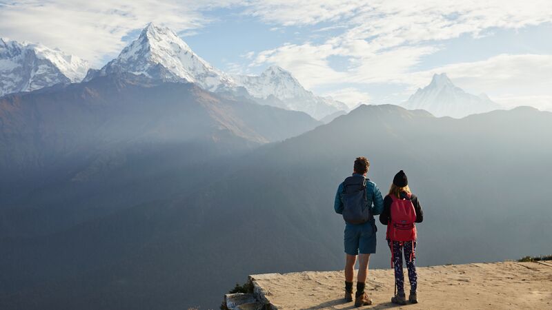 Two hikers looking at mountains in Nepal.