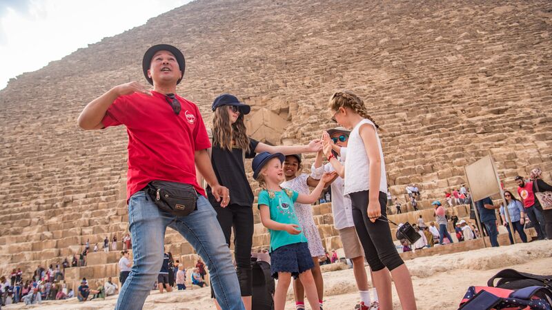 A tour leader and some kids at the pyramids in Egypt