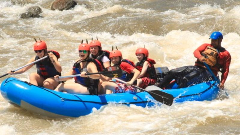 A group of people white-water rafting