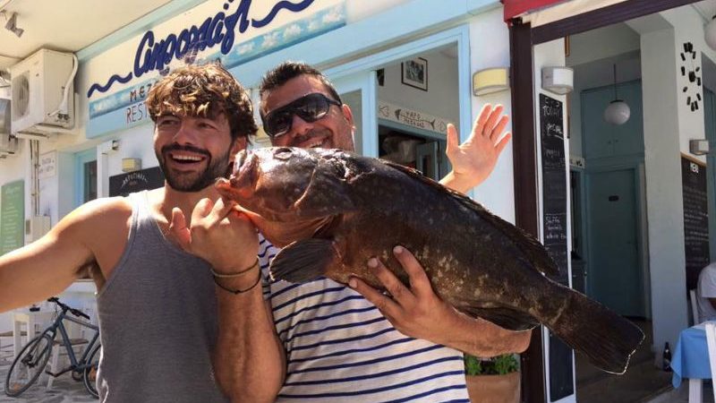 Two men holding a big fish in Greece