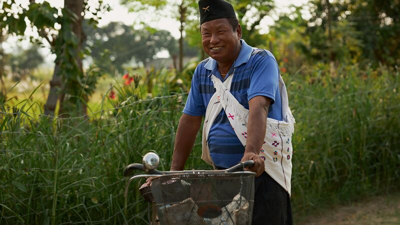 A man in Nepal with a bicycle.