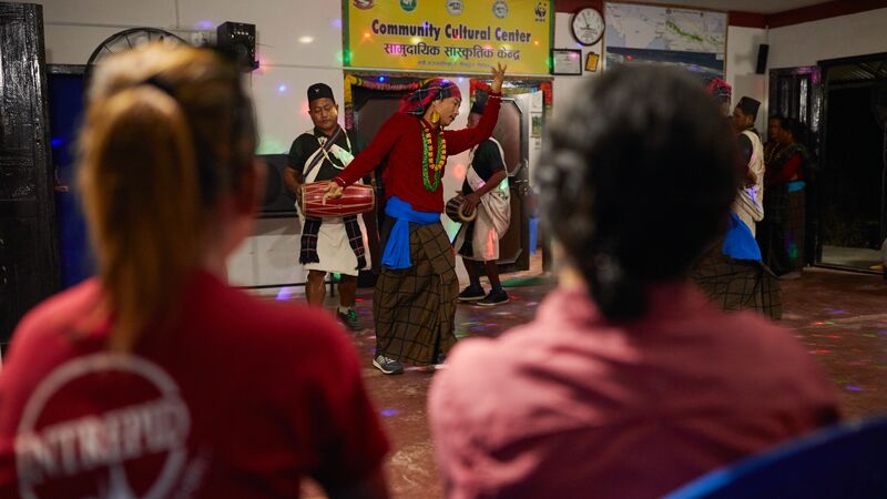 A group of travellers watching a cultural performance in Nepal.