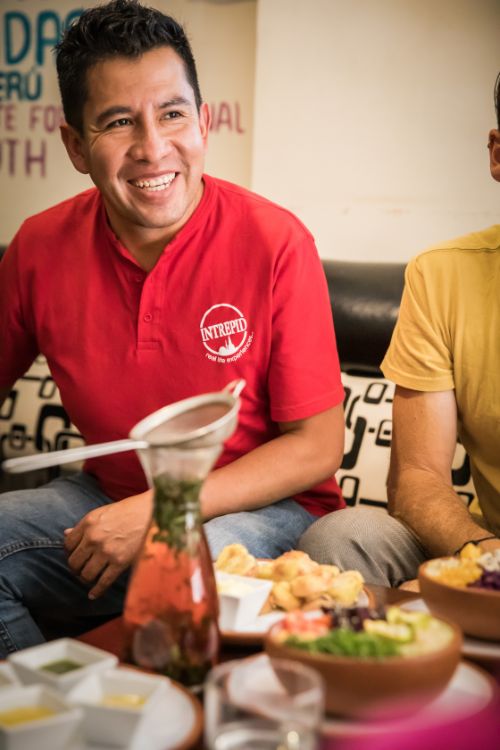 A tour leader smiles at his group