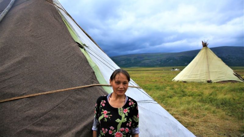 A Nenet woman in Siberia standing in front of her tent