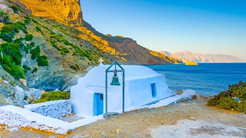 A small white church next to the sea in Amorgos, Greek Islands