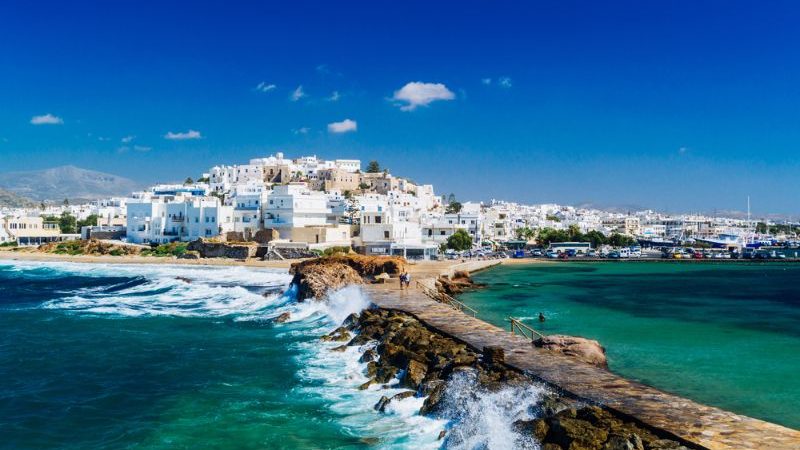 View of Naxos town and breaking waves