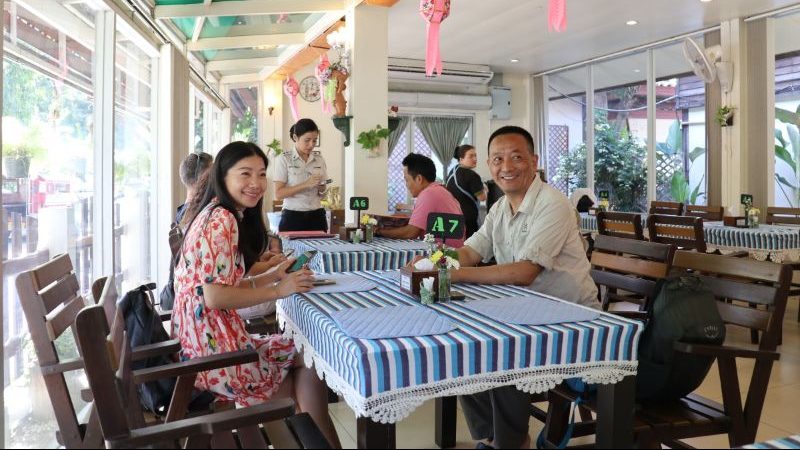 Two people sitting in a restaurant in Chiang Mai