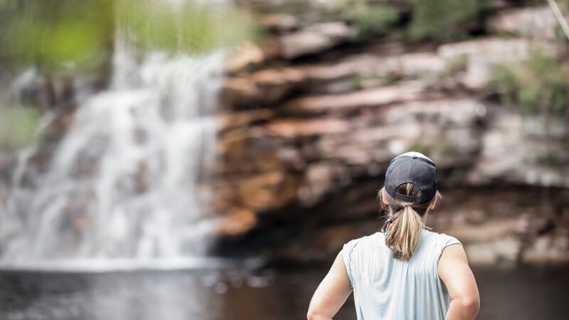 A traveller looks at a waterfall