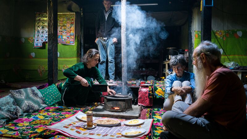 Three people sitting in a homestay in Pakistan