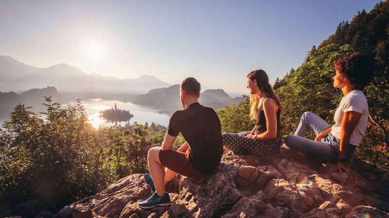 Three travellers sitting on a mountain in Slovenia