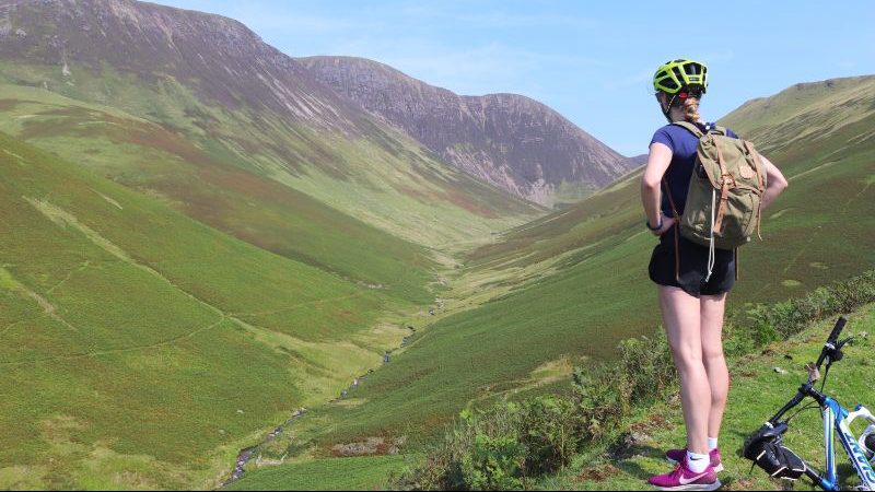 Cyclist staring at the green hills