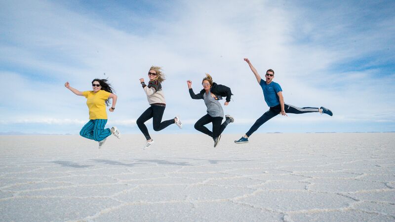 Travellers jumping in salar-de-uyuni-salt-flats