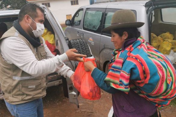 MEDLIFE rep making a donation to a porter