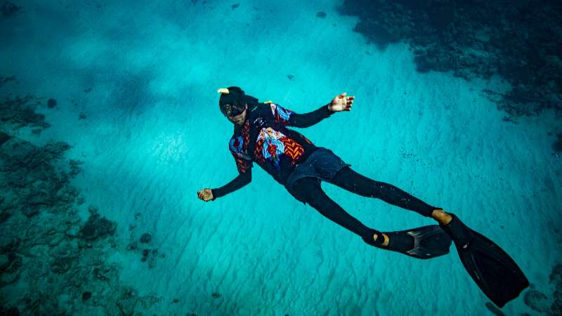 snorkeler swiming under water
