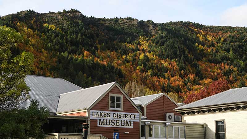 The Lakes District Museum with lush vegetation in the background.