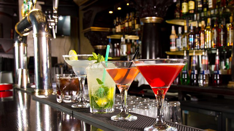 Five cocktails on a bar top