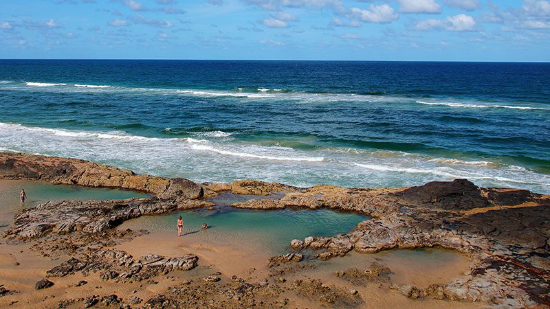 People swimming in Champagne Pools on Fraser Island