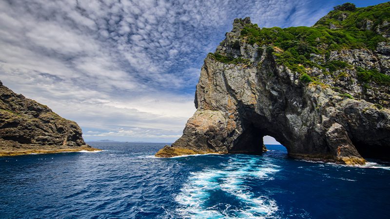 The 'Hole in the Rock' formation in the Bay of Islands, New Zealand.