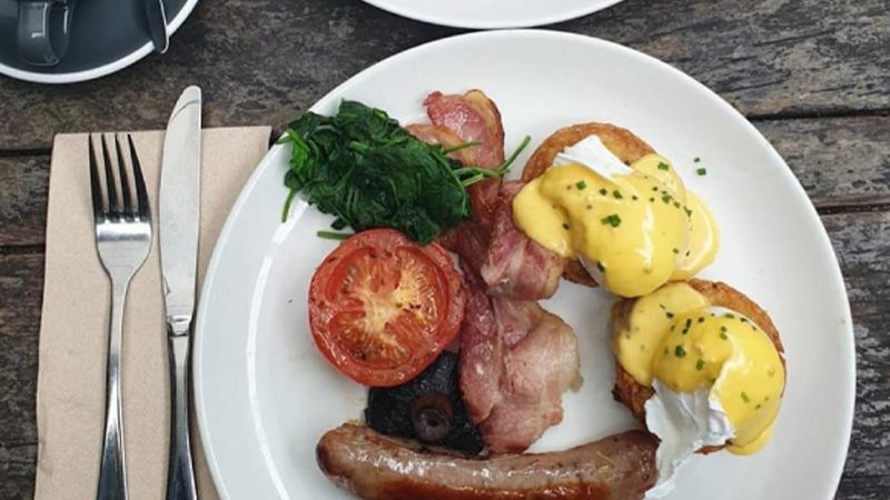 Eggs benedict with breakfast sides at Olive restaurant in Wellington.