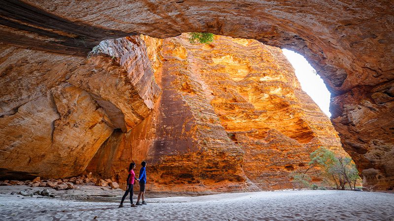 Couple wandering through Cathedral Gorge in the Bungle Bungle range.