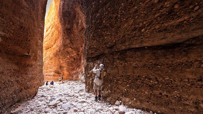 Traveller marveling at the width of Echidna Chasm in the Bungle Bungles range.