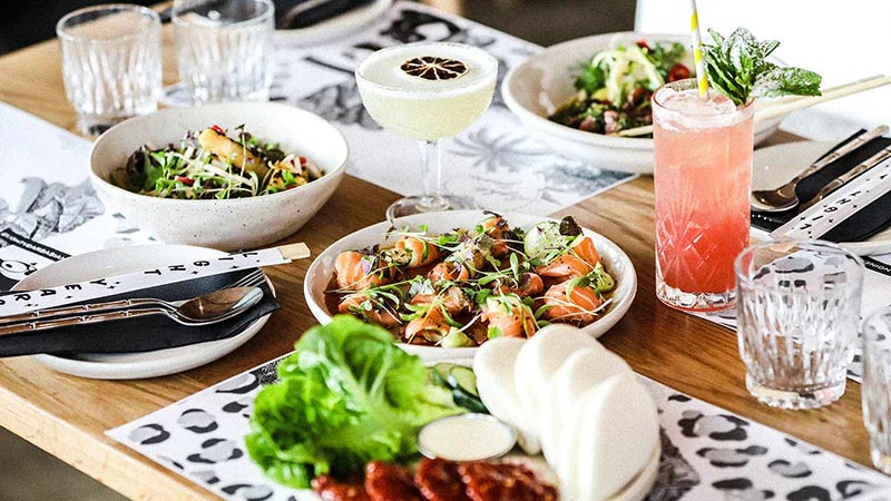 A table spread with dishes and drinks from Light Years in Noosa. 
