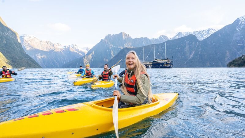 A group of kayakers having fun on the water in Milford Sound