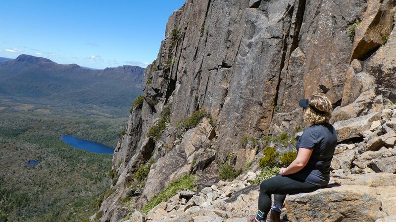 Traveller looking out from the Cradle Mountain summit in Tasmania.