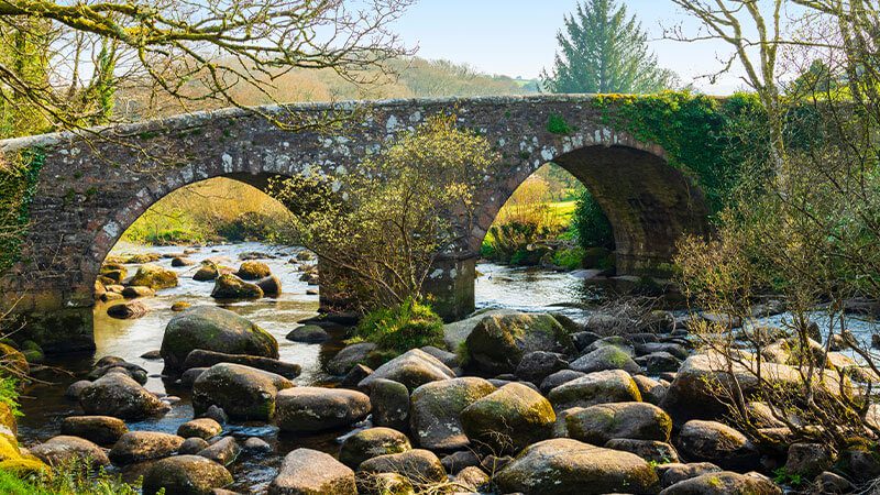 Moss-covered rocks under Dartmeet Bridge in Devon