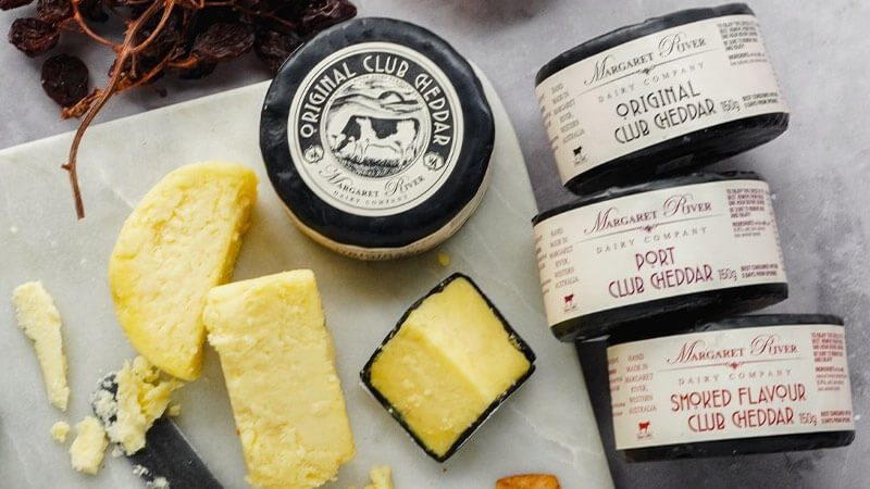 Blocks of cheddar from Margaret River Dairy Company on a chopping board