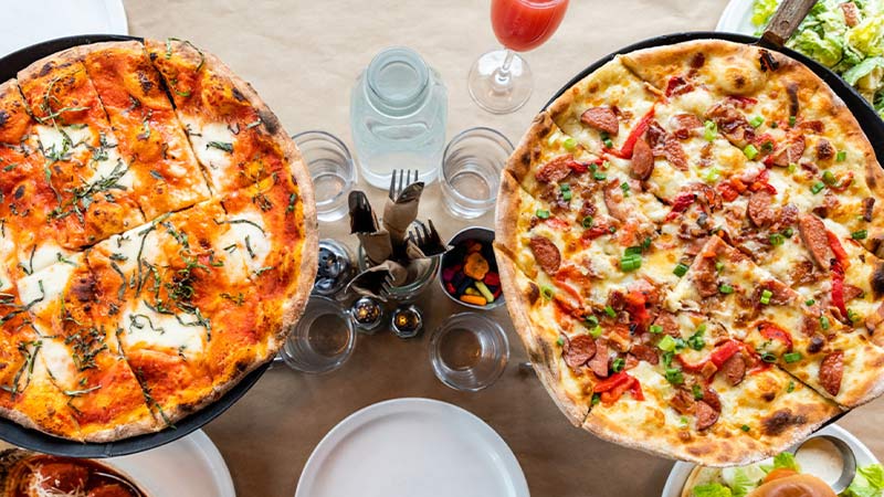 Two pizzas on the table at Fat Ptarmigan in Anchorage