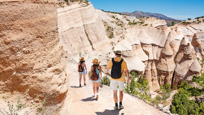 Travelers walking through Kasha Katuwe National Monument in New Mexico. 