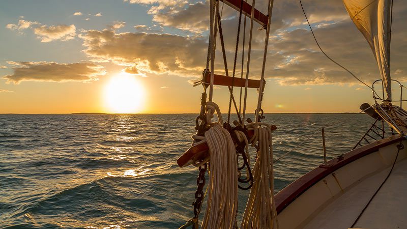A sailing boat anchored to watch sunset in Key West