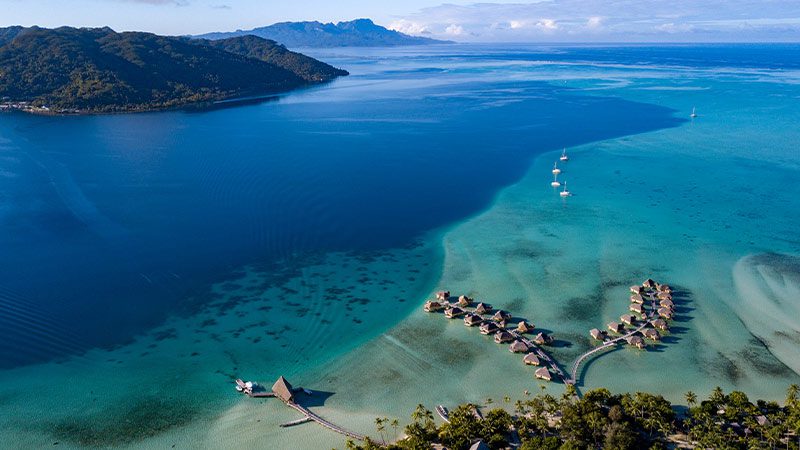 Aerial view of Taha'a with its over the water bungalows and islands full of lush vegetation