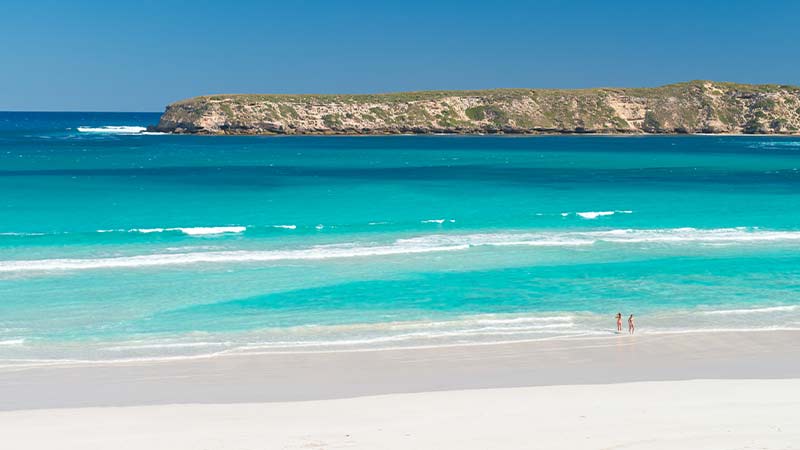 Two people walking along Almonta Beach on the Eyre Peninsula