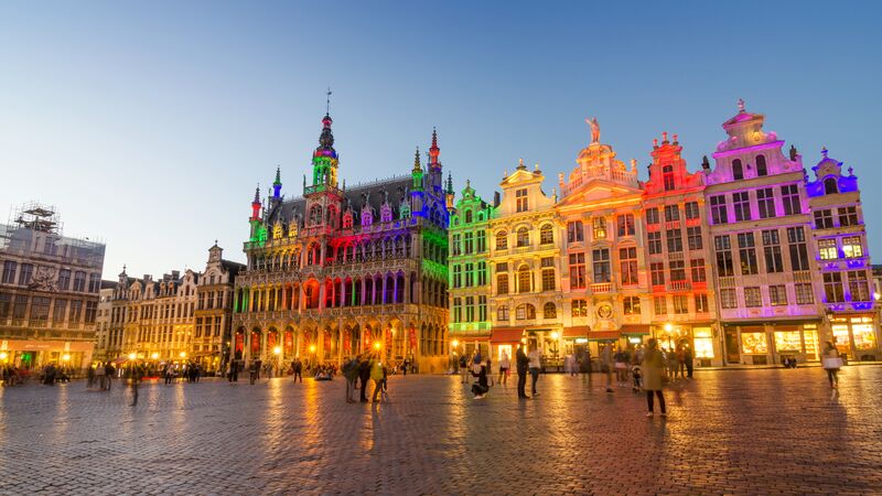 Bright neon lights lighting up old buildings in Brussels 