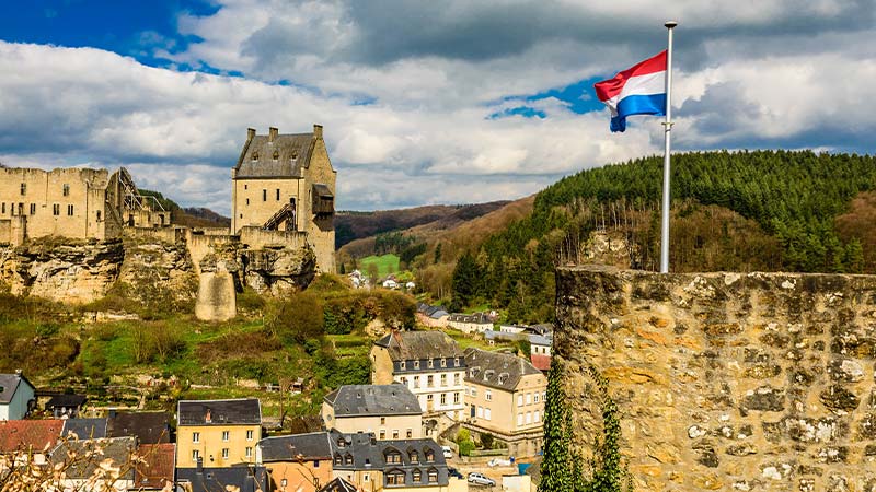 The storybook houses and buildings in Larochette with a French flag flying in the foreground.