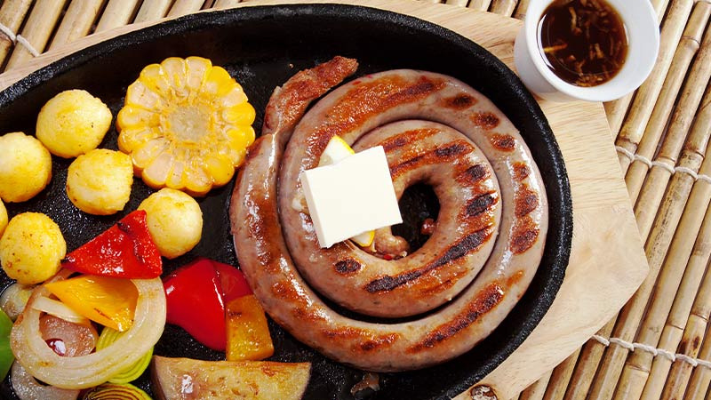 A plate of mutura, corn and vegetables