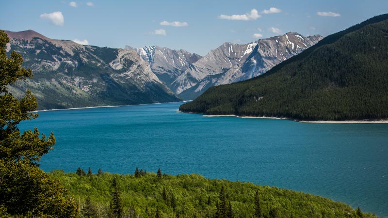 A beautiful turquoise lake at the base of several mountains along Aylmer Pass.